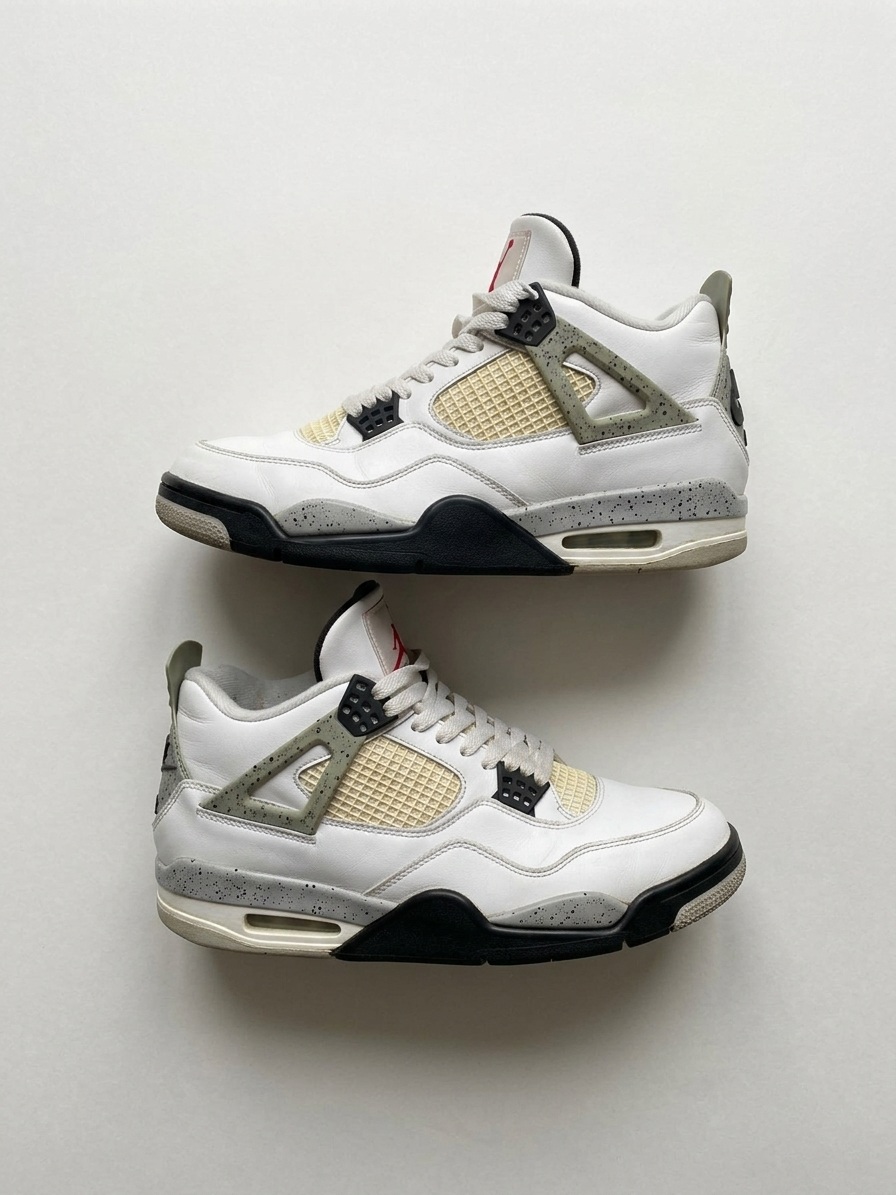 The same pair of Air Jordan 4 sneakers re-shot from above on a pale studio background, both shoes in profile